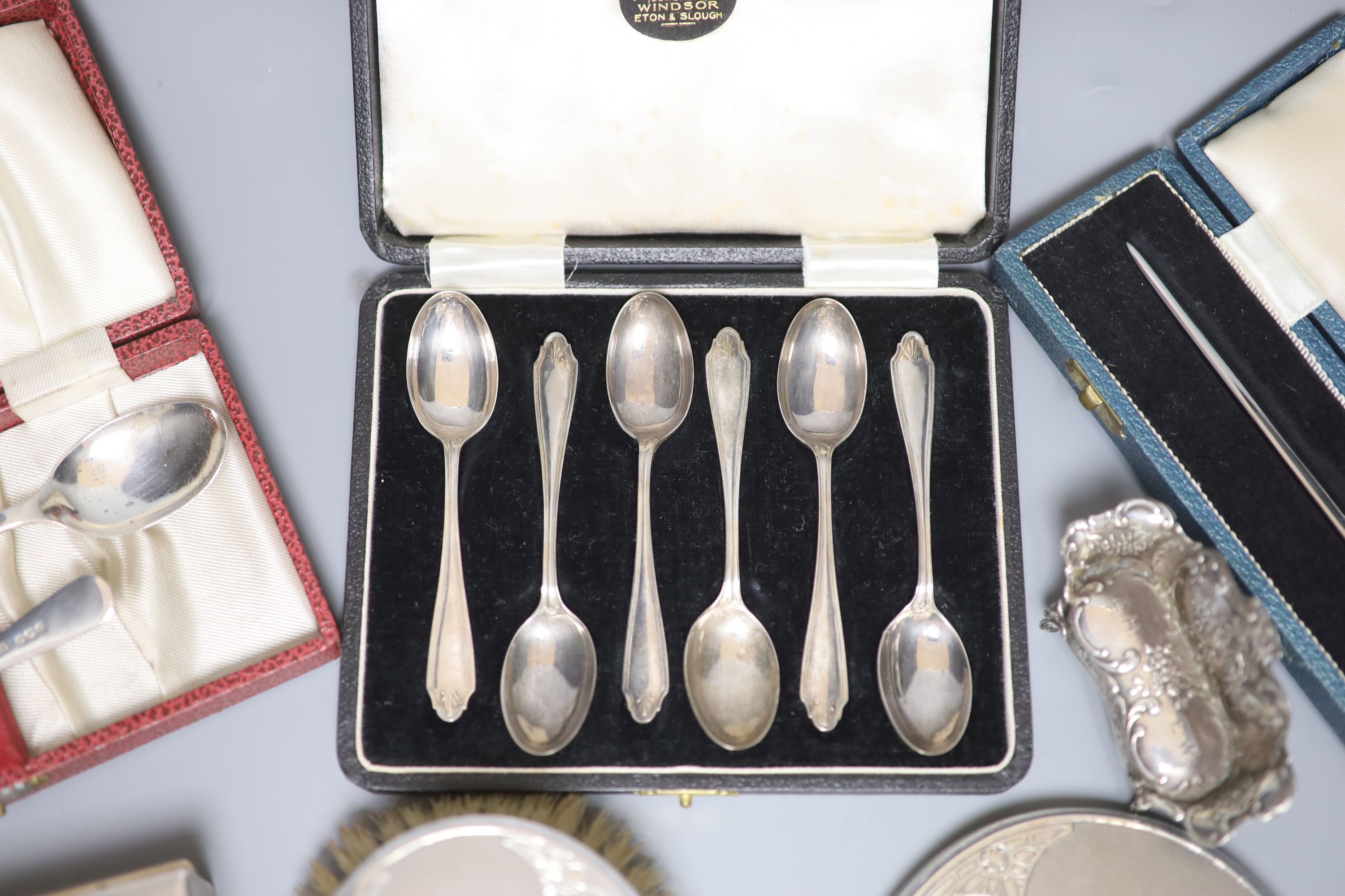 A silver cigarette case, brush set, cased spoons etc and a late Victorian miniature silver settee, Sheffield, 1897.